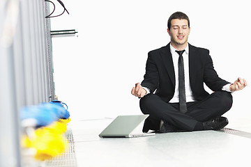 Image showing business man practice yoga at network server room