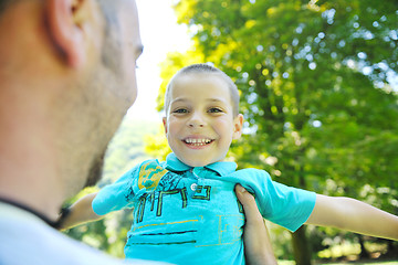 Image showing happy father and son have fun at park