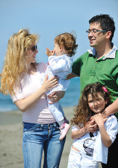 Image showing happy young family have fun on beach