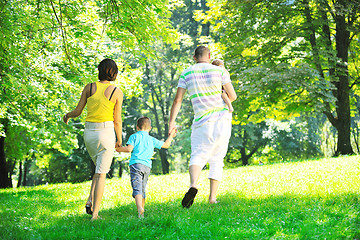 Image showing happy young couple with their children have fun at park