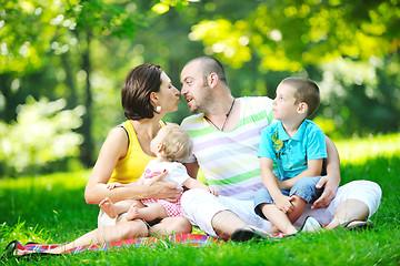 Image showing happy young couple with their children have fun at park