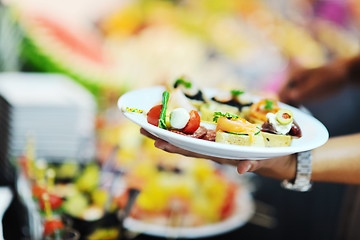 Image showing womanl chooses tasty meal in buffet at hotel