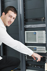 Image showing young it engeneer in datacenter server room