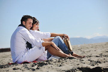 Image showing young couple enjoying  picnic on the beach