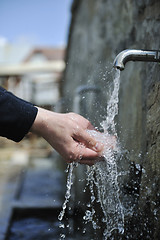 Image showing fresh mountain water falling on hands