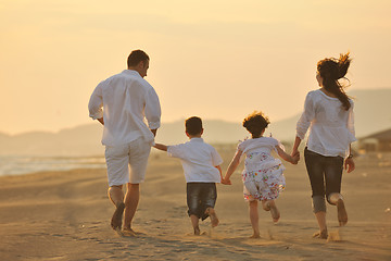 Image showing happy young family have fun on beach at sunset