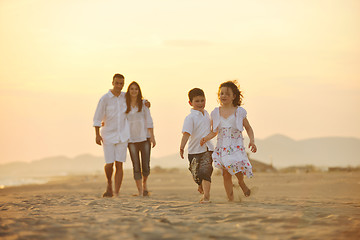 Image showing happy young family have fun on beach at sunset