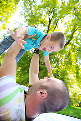 Image showing happy father and son have fun at park