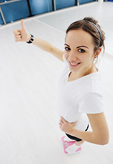 Image showing happy diet concept with young woman on pink scale