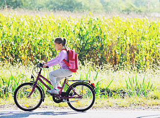 Image showing schoolgirl traveling to school on bicycle