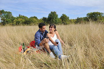 Image showing happy couple enjoying countryside picnic in long grass