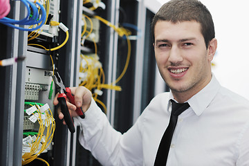 Image showing young it engeneer in datacenter server room