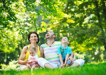 Image showing happy young couple with their children have fun at park