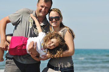 Image showing happy young family have fun on beach