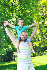 Image showing happy father and son have fun at park