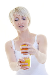 Image showing Young woman squeeze orange juice