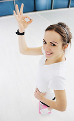 Image showing happy diet concept with young woman on pink scale