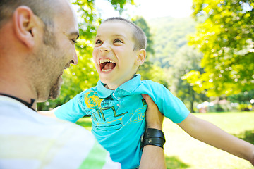 Image showing happy father and son have fun at park