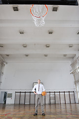 Image showing businessman holding basketball ball