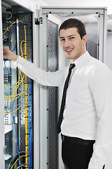 Image showing young it engeneer in datacenter server room