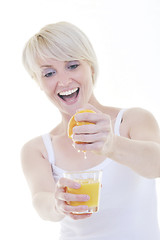 Image showing Young woman squeeze orange juice