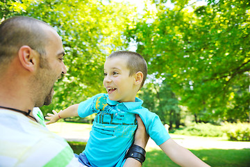 Image showing happy father and son have fun at park