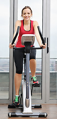 Image showing womanworkout  in fitness club on running track machine 