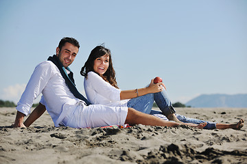 Image showing young couple enjoying  picnic on the beach