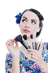 Image showing beautiful young woman applying makeup