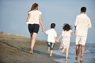 Image showing happy young family have fun on beach