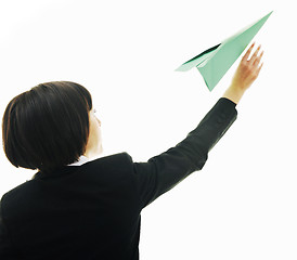 Image showing business woman throwing  paper airplane 