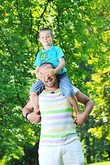 Image showing happy father and son have fun at park