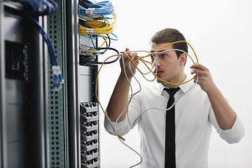 Image showing young it engeneer in datacenter server room