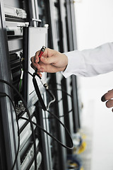 Image showing young it engeneer in datacenter server room