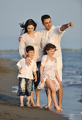 Image showing happy young family have fun on beach at sunset