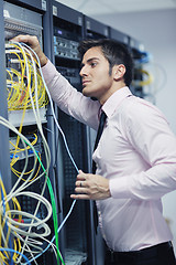 Image showing young it engeneer in datacenter server room