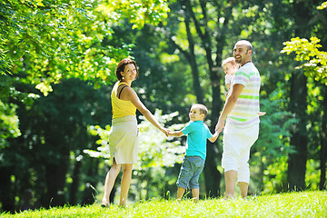 Image showing happy young couple with their children have fun at park