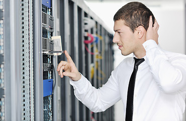 Image showing young it engeneer in datacenter server room