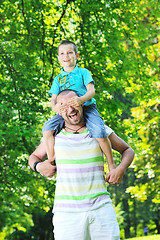 Image showing happy father and son have fun at park