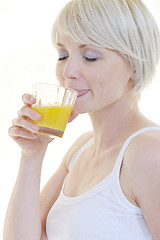 Image showing Young woman squeeze orange juice