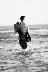 Image showing Portrait of a young  kitsurf  man at beach on sunset