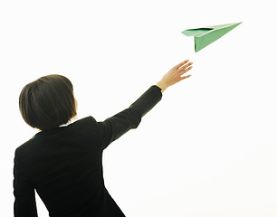 Image showing business woman throwing  paper airplane 