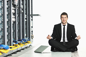 Image showing business man practice yoga at network server room