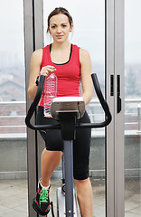 Image showing woman workout  in fitness club on running track 