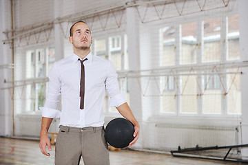 Image showing businessman holding basketball ball