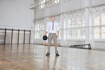 Image showing businessman holding basketball ball