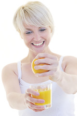 Image showing Young woman squeeze orange juice