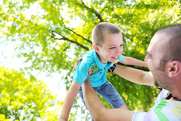 Image showing happy father and son have fun at park