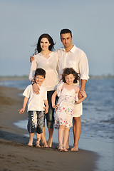 Image showing happy young family have fun on beach at sunset