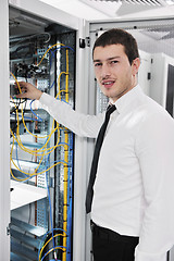 Image showing young it engeneer in datacenter server room